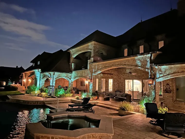 Landscape lighting by TC Lighting in Dallas, TX — photographed after dark on the property