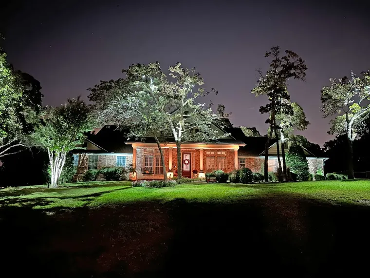 Landscape lighting by TC Lighting in Dallas, TX — photographed after dark on the property