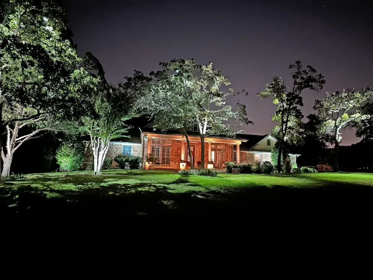 Landscape lighting by TC Lighting in Dallas, TX — photographed after dark on the property