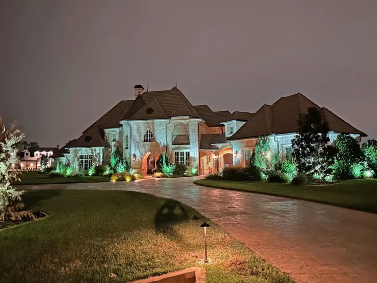 Landscape lighting by TC Lighting in Dallas, TX — photographed after dark on the property