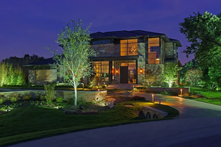 Landscape lighting by TC Lighting in Flower Mound, TX — photographed after dark on the property