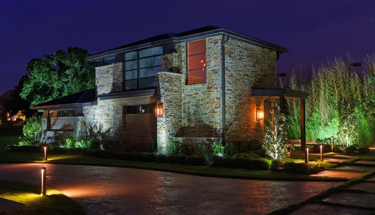 Landscape lighting by TC Lighting in Flower Mound, TX — photographed after dark on the property