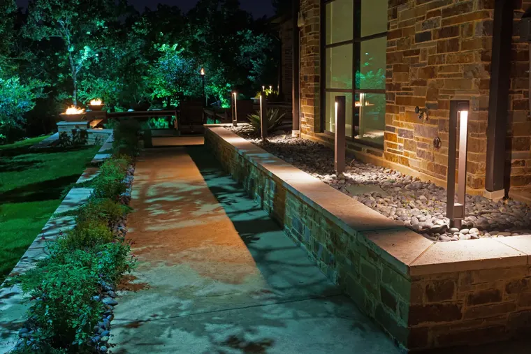 Landscape lighting by TC Lighting in Flower Mound, TX — photographed after dark on the property