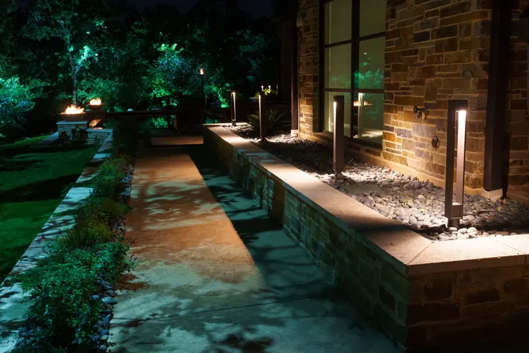 Landscape lighting by TC Lighting in Flower Mound, TX — photographed after dark on the property