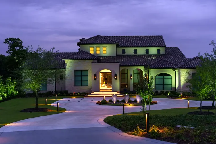 Landscape lighting by TC Lighting in Flower Mound, TX — photographed after dark on the property