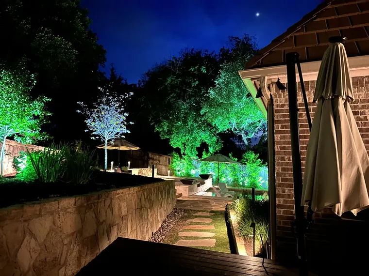 Landscape lighting by TC Lighting in Fort Worth, TX — photographed after dark on the property