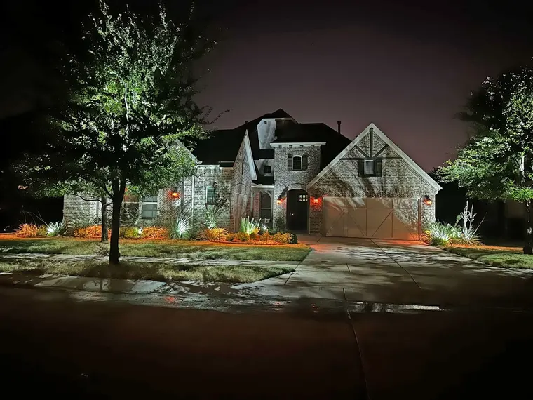 Landscape lighting by TC Lighting in Grapevine, TX — photographed after dark on the property
