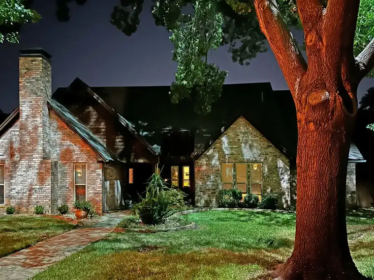 Landscape lighting by TC Lighting in Grapevine, TX — photographed after dark on the property