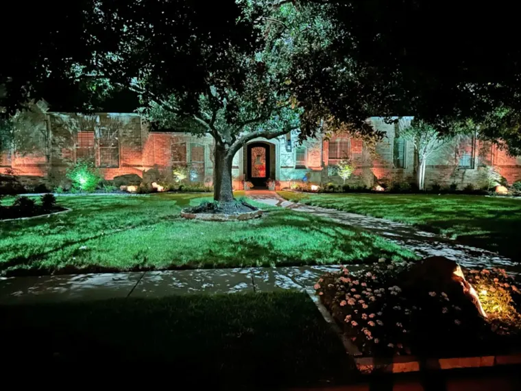 Landscape lighting by TC Lighting in Preston Hollow, Dallas — photographed after dark on the property