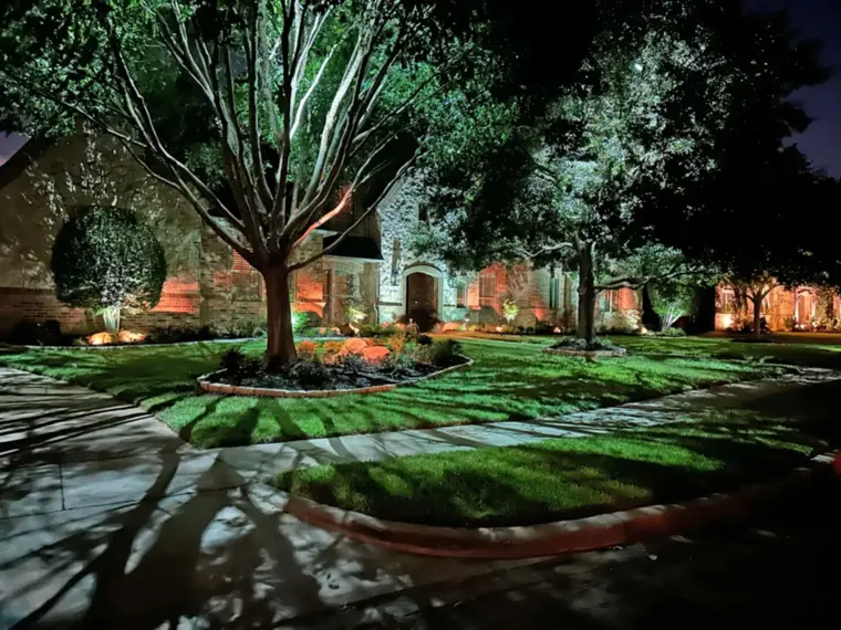 Landscape lighting by TC Lighting in Preston Hollow, Dallas — photographed after dark on the property
