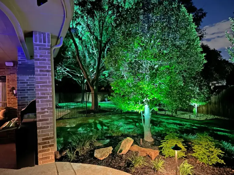 Landscape lighting by TC Lighting in Preston Hollow, Dallas — photographed after dark on the property