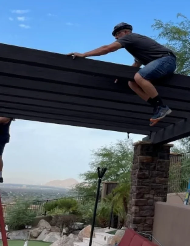 A TC Lighting installer working on top of a ramada in Arizona, fitting downlights into the structure