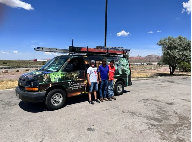 The TC Lighting van and crew on an Arizona job, parked with desert mountains behind them